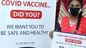 Vaccinated woman in front of banner reading 