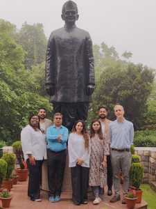 A group photo of the Johns Hopkins team, consisting of members from GKII and the UP Health Systems Strengthening Project, posing in front of the statue of Lal Bahadur Shastri at the Lal Bahadur Shastri National Academy of Administration (LBSNAA) in Mussoorie. The team delivered the FNER simulation training at LBSNAA on July 3, 2024.